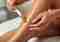 A beautician applying wax on a woman's lower leg during a body waxing session at Zen House Spa and Wellness center in Marbella Puerto Banus.
